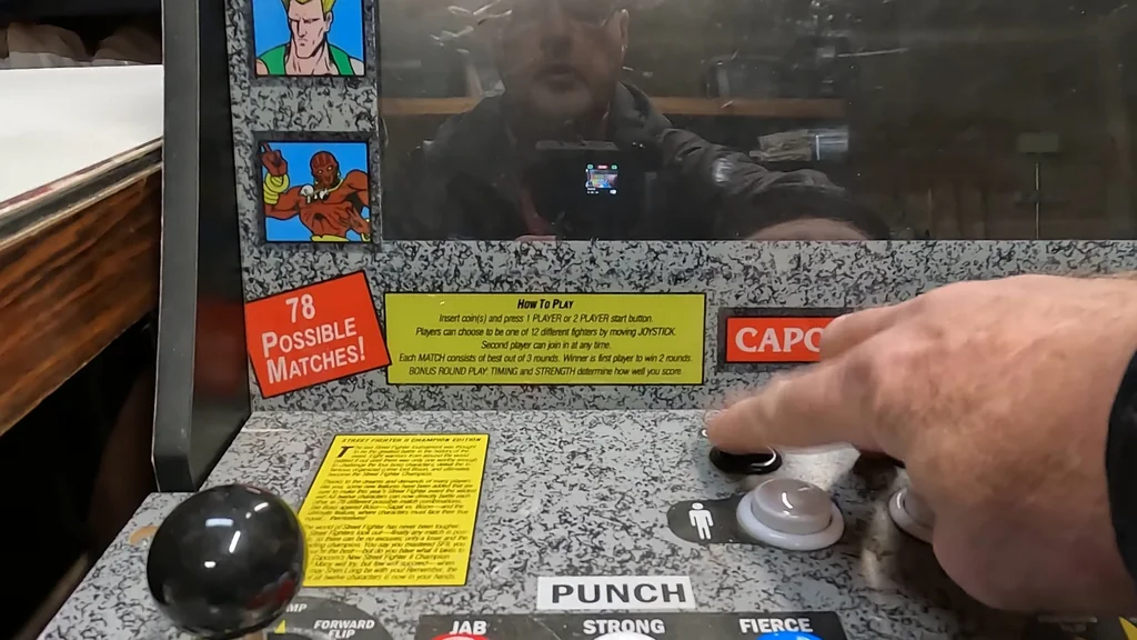 Pressing the power button on the arcade cabinet.