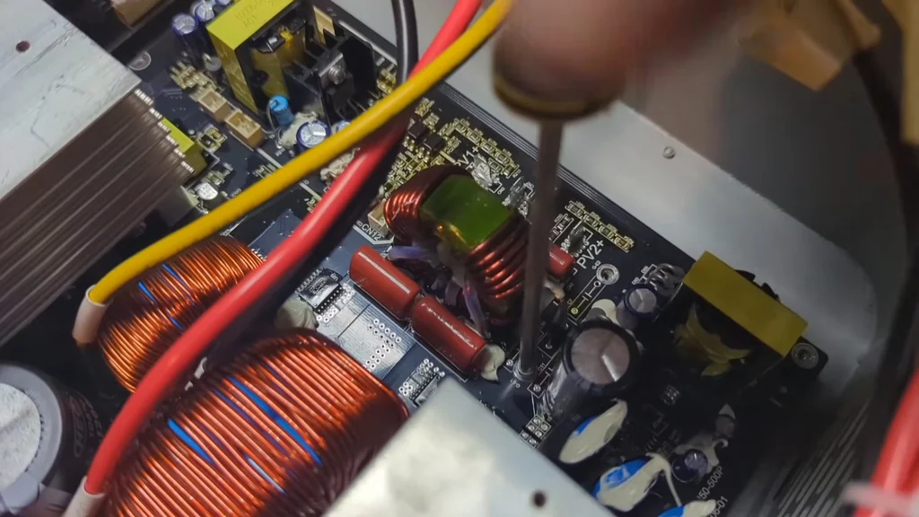 Tightening a mounting screw on the power distribution board.
