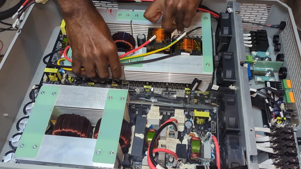 Assembling the internal components and housing of the solar inverter.