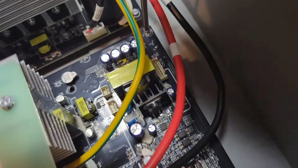 Adjusting small variable components on the inverter board.