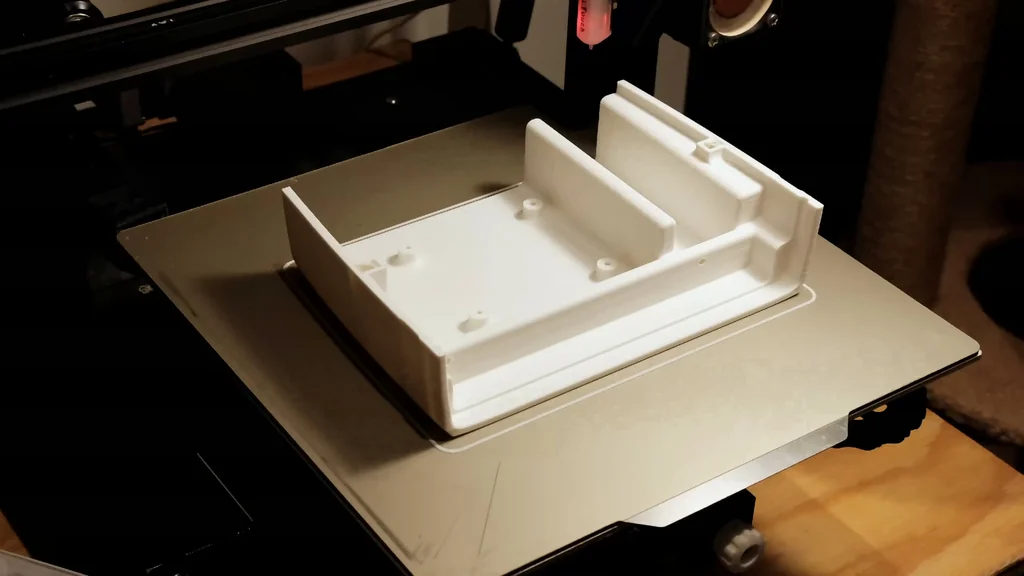 3D printer producing the white bottom case cover