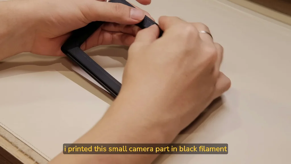 Assembling the black 3D printed camera part