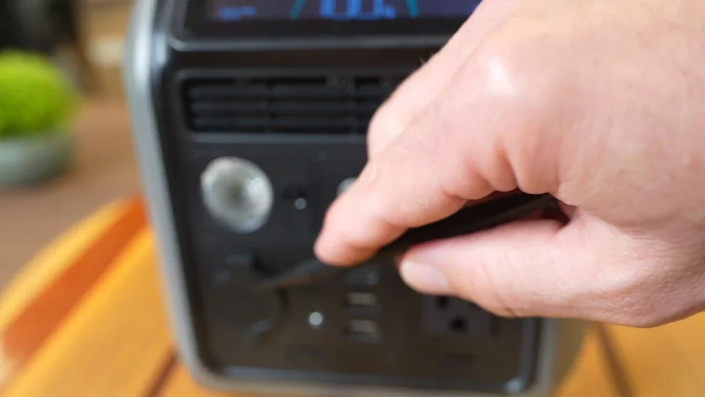 Opening the DC car outlet and input ports