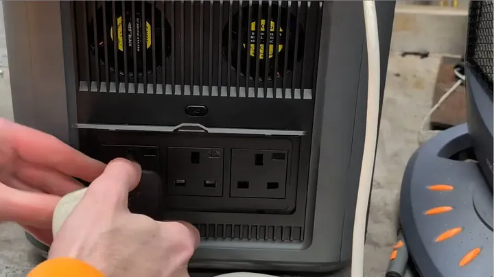 Two UK plugs jammed awkwardly into adjacent outlets demonstrating tight socket spacing issue