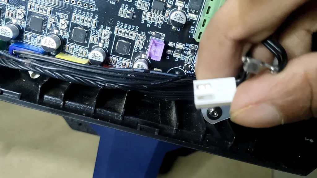Technician inspecting the printer's internal wiring and PCB