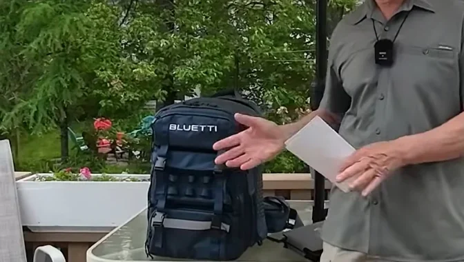 Man holding Bluetti backpack and solar panel