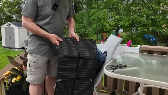 Man unfolding the solar panel