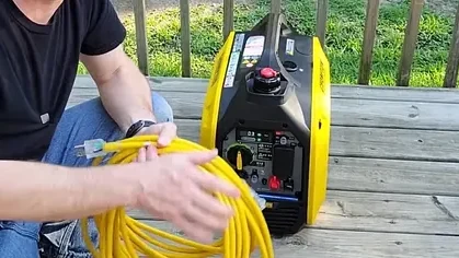 Extension cord plugged into manual home transfer switch panel above breaker box