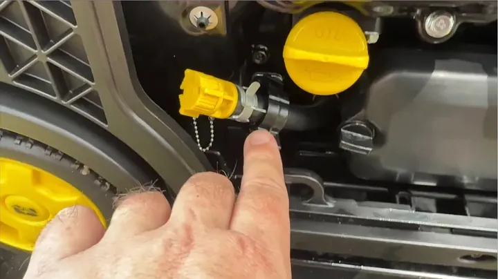 Oil drain tube clipped into frame with custom angled funnel inserted into fill port