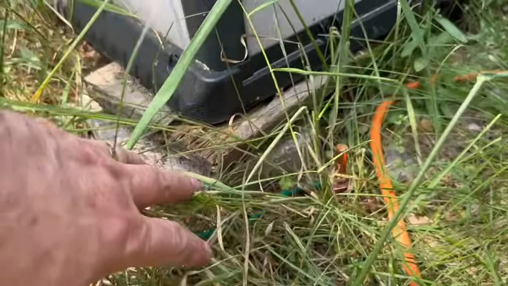 Hand touching orange wire