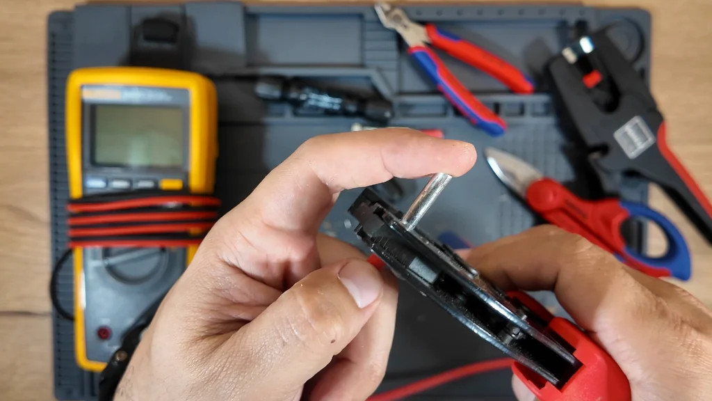 Crimping tool jaws compressing the metal contact onto the wire