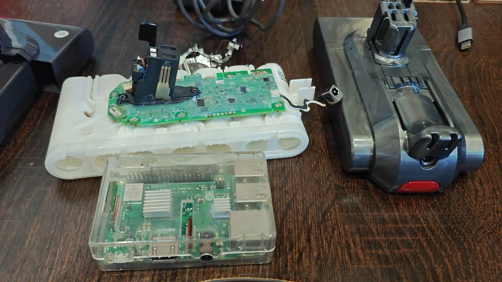 Hand holding Raspberry Pi over battery