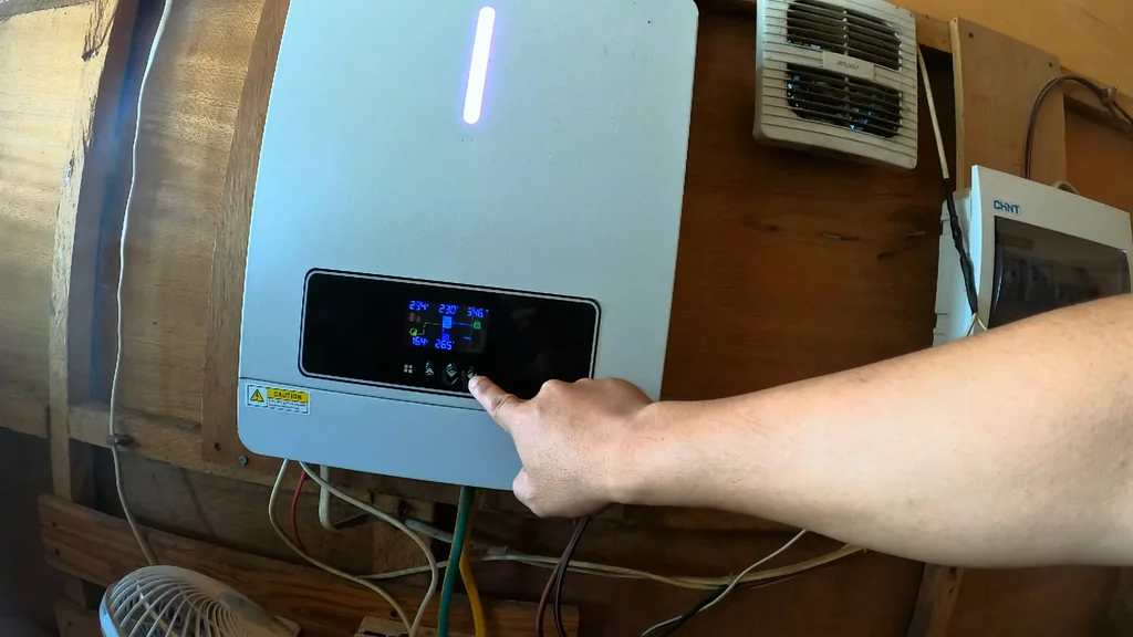 Hand adjusting settings on the inverter.