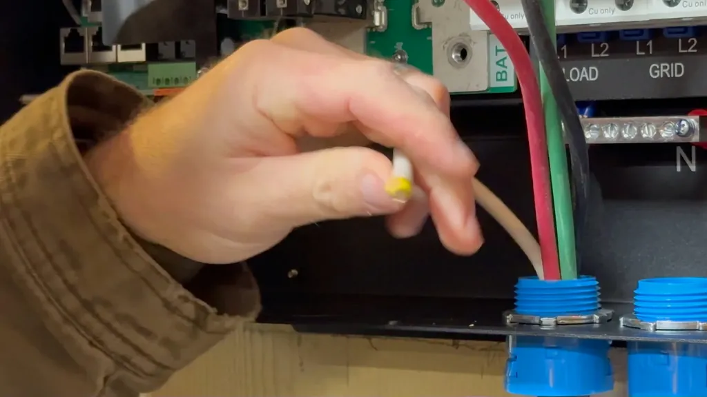 Torque screwdriver being used on an inverter terminal block.