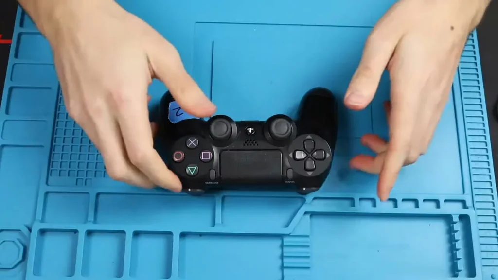 Holding PS4 controller for inspection