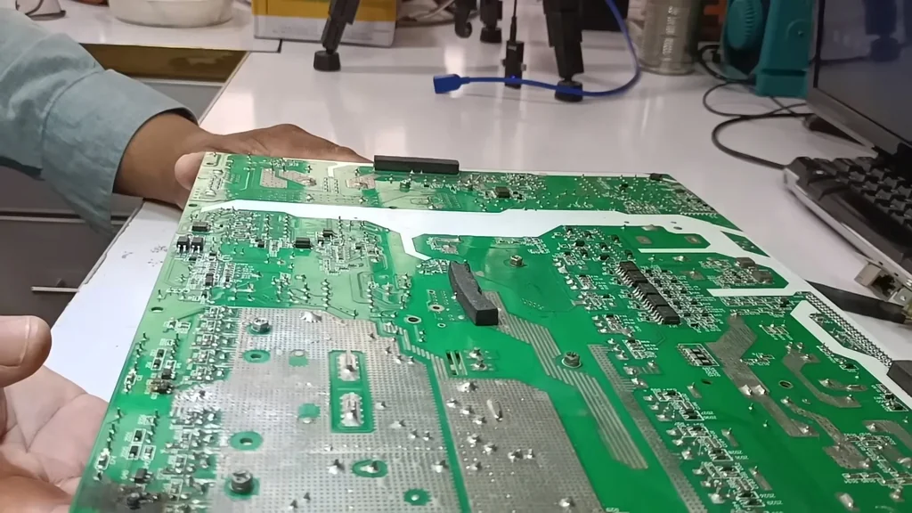 Inspecting the green PCB under a microscope
