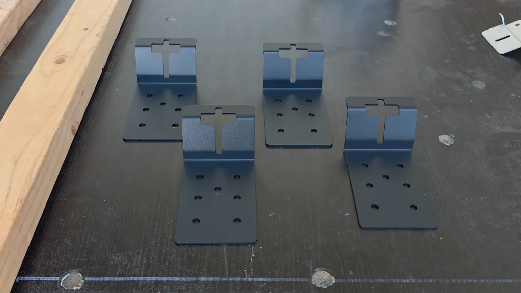 Four green steel T-posts and black metal mounting brackets.