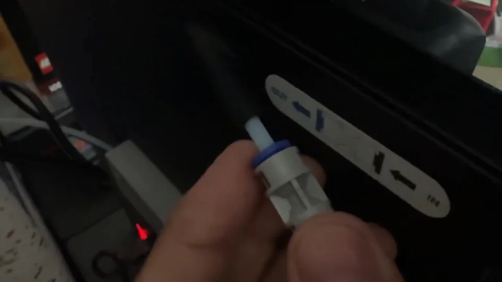 Hand holding a 3D printer filament coupler