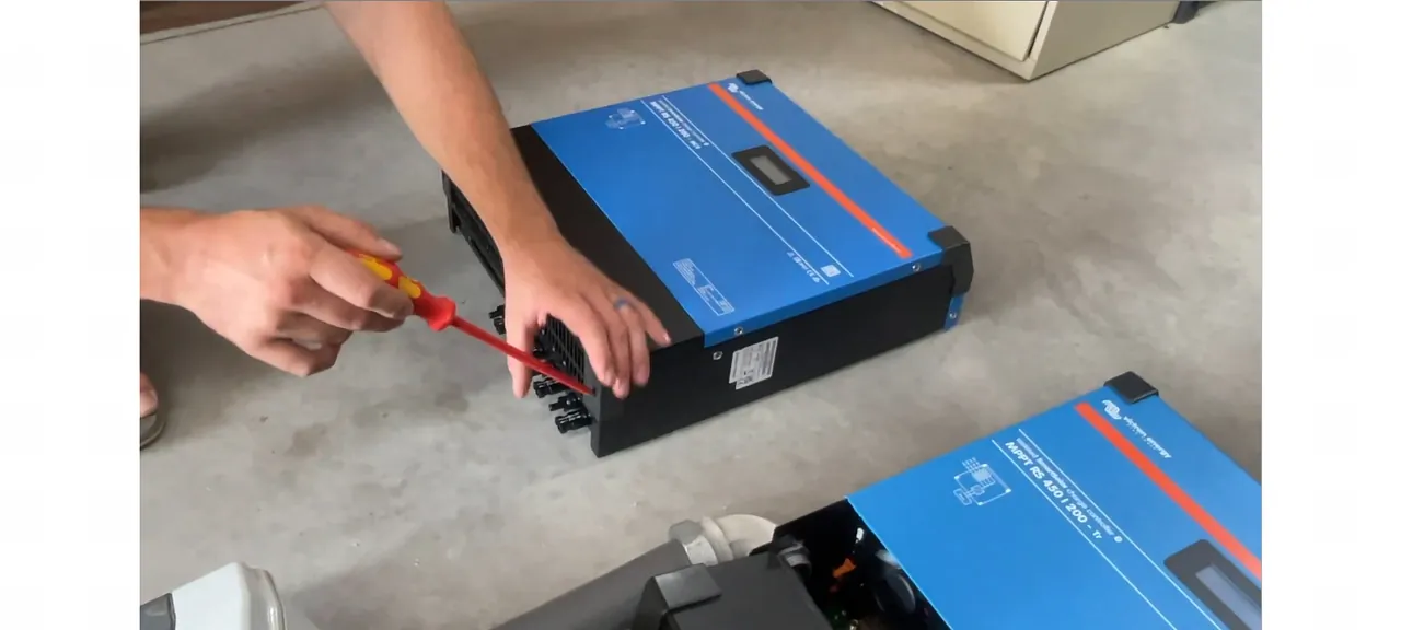 Technician removing the terminal cover screws