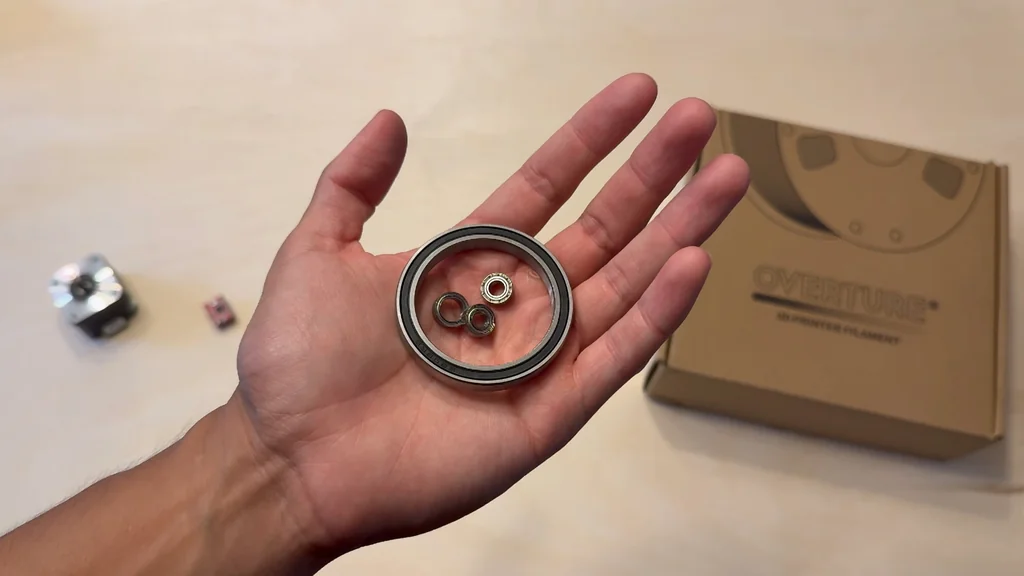 Hand holding various sizes of ball bearings
