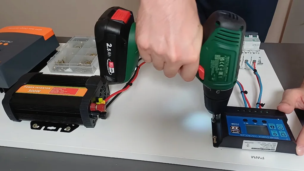 Using a cordless drill to mount components on the solar board