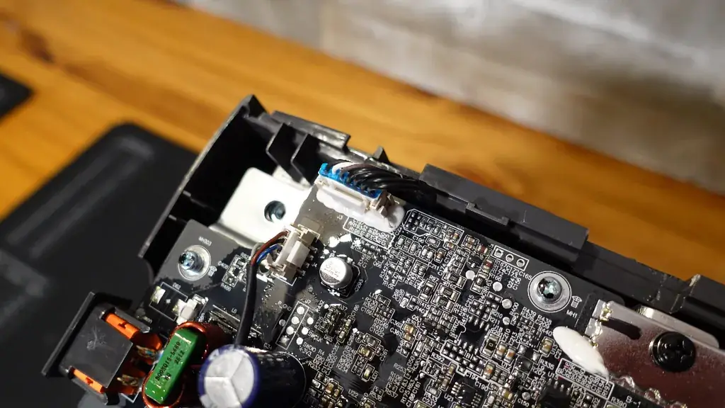Screwdriver removing screws from the inverter board