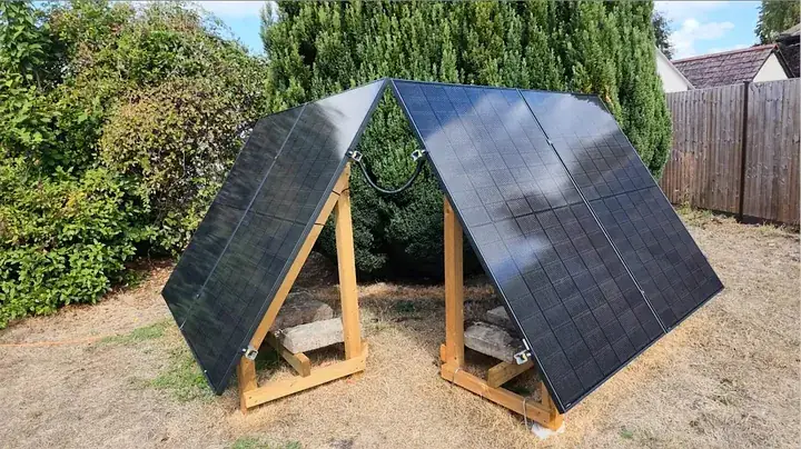 Heavy concrete masonry blocks resting on timber support rails anchoring the solar frame