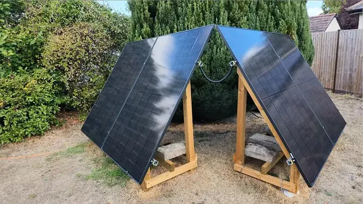 Close-up view of MC4 cross-wiring cables connecting parallel solar panel pairs across two ground frames
