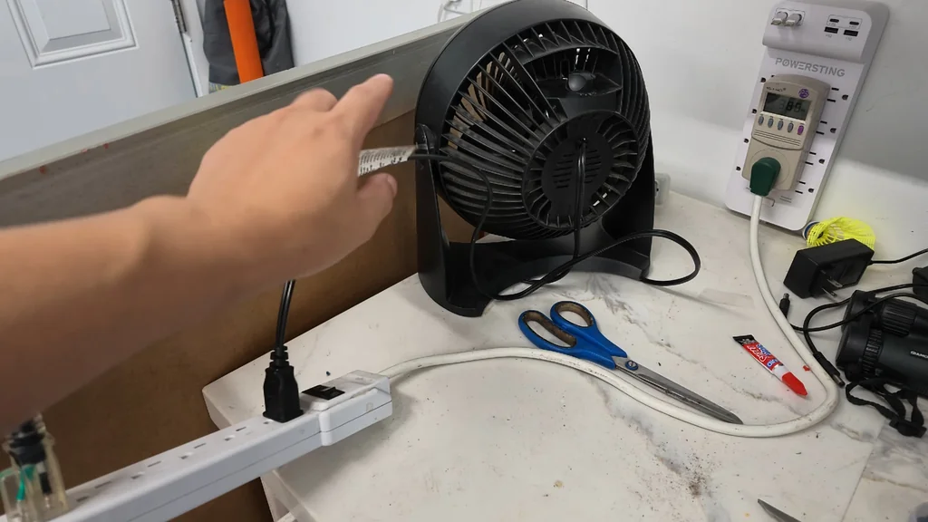 Unplugging the fan to check the meter