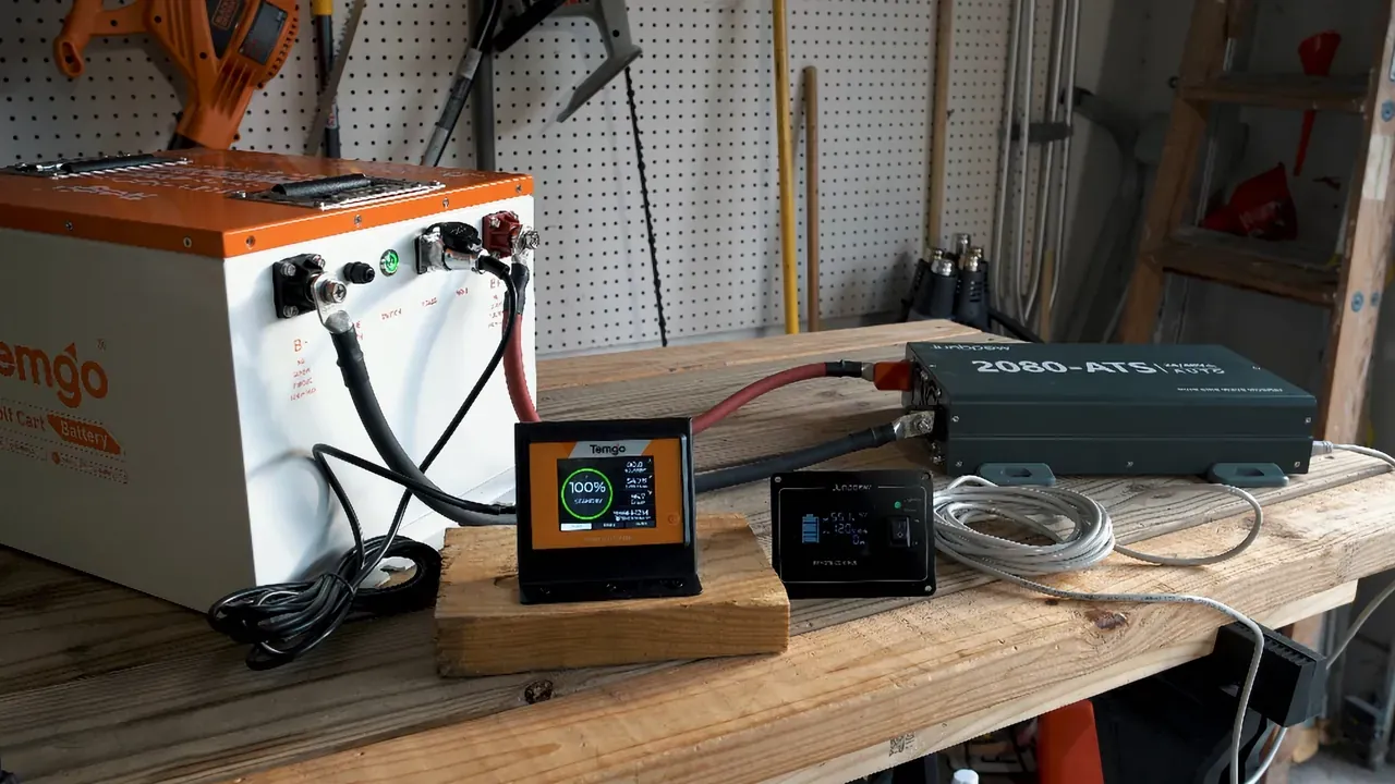 Inverter and battery setup on a workbench.