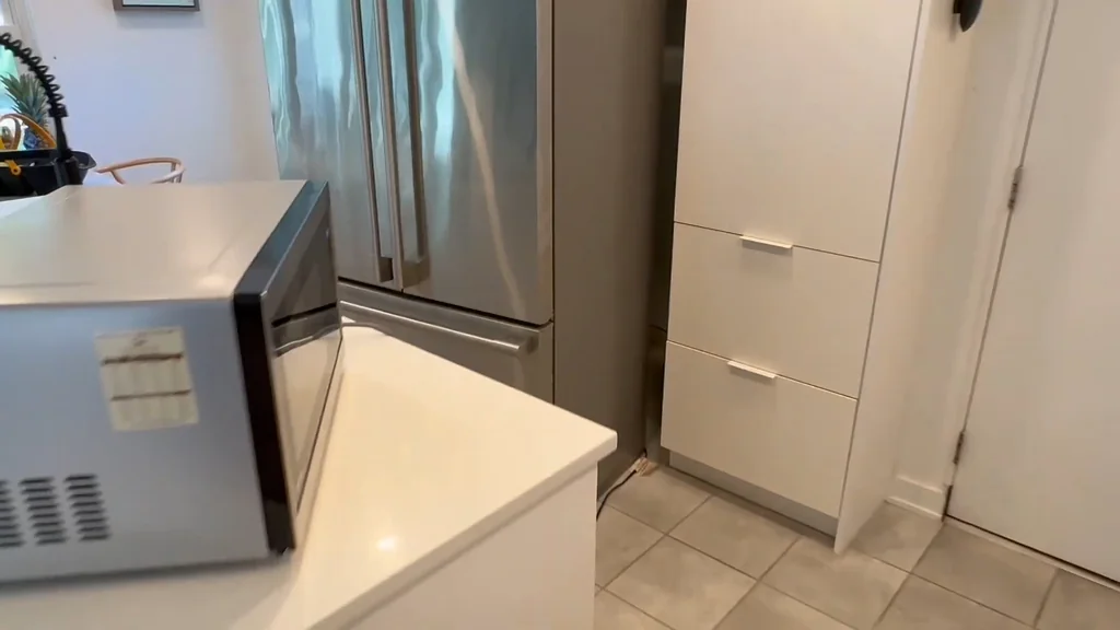 Microwave and refrigerator in a kitchen setting