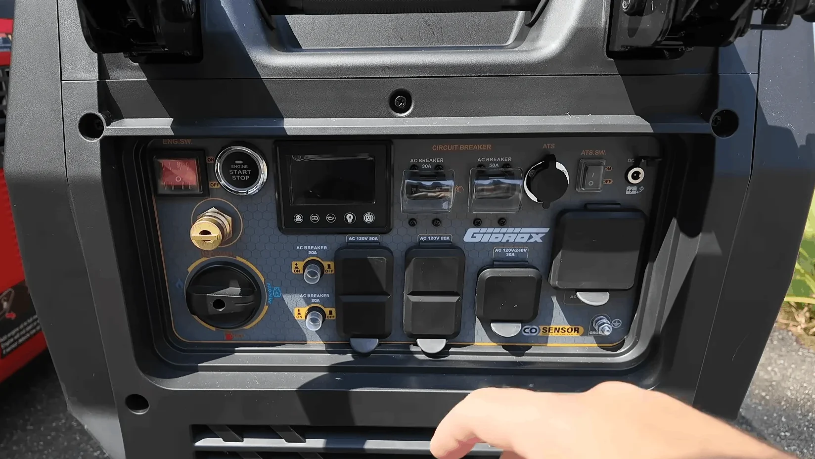 Close-up of the Gidrox generator control panel showing receptacles and fuel selector dial