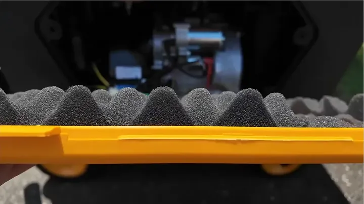 Close-up of thick acoustic insulation foam inside the Predator removable service panel