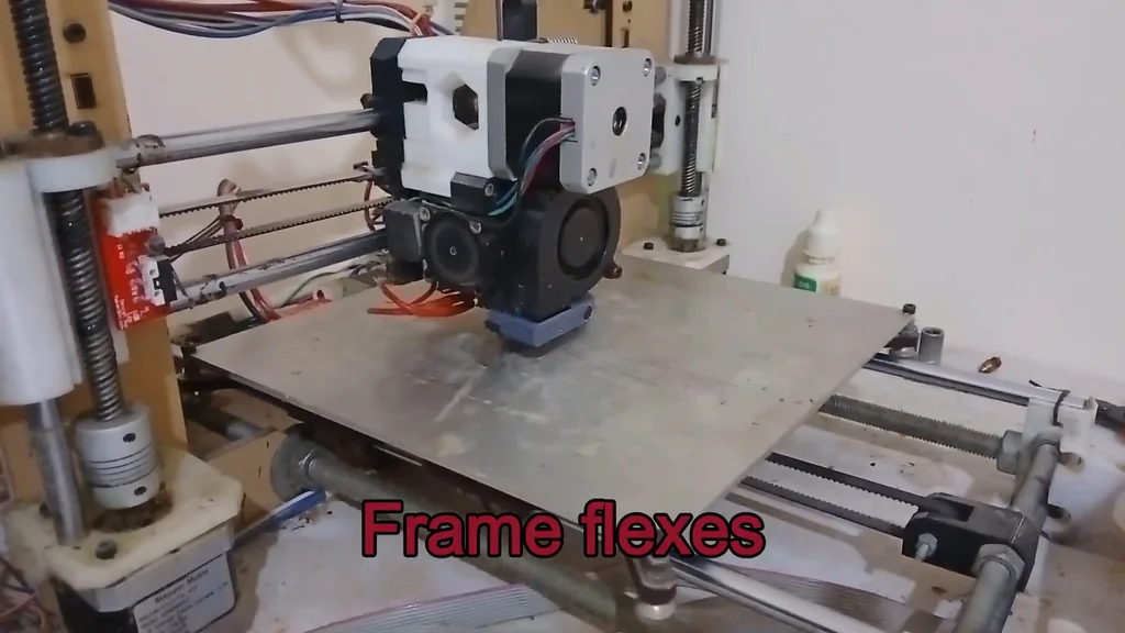 3D printer with frame flexes text overlay