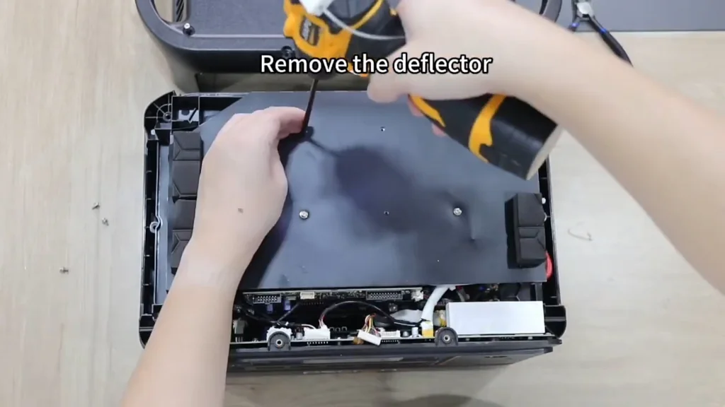 Removing the deflector with an electric screwdriver