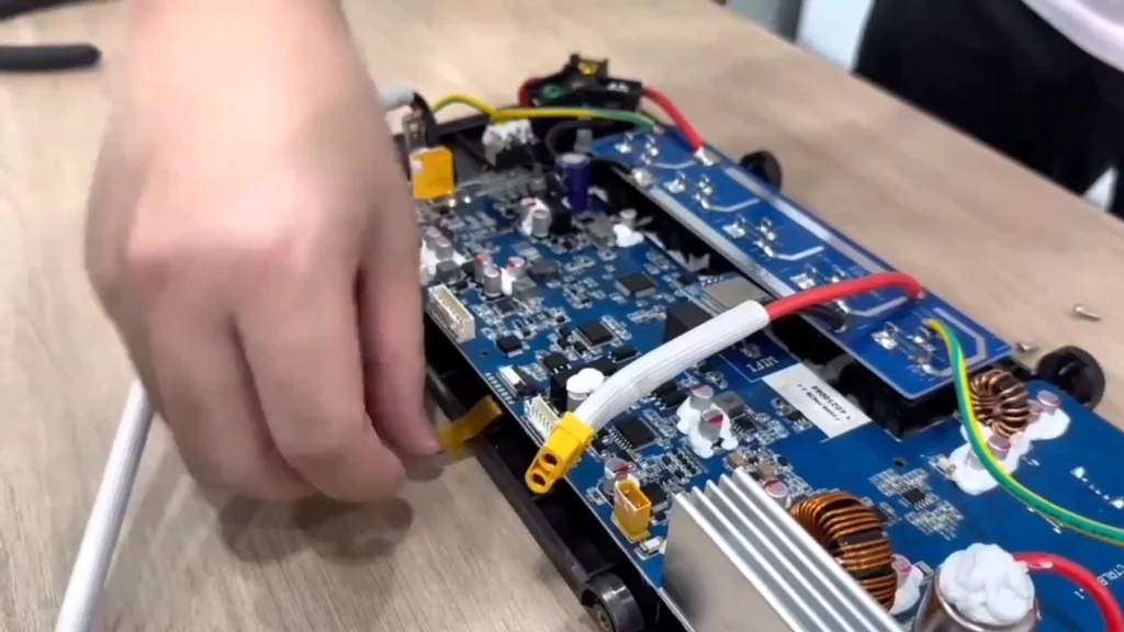 Disconnecting the yellow ribbon cable from the board