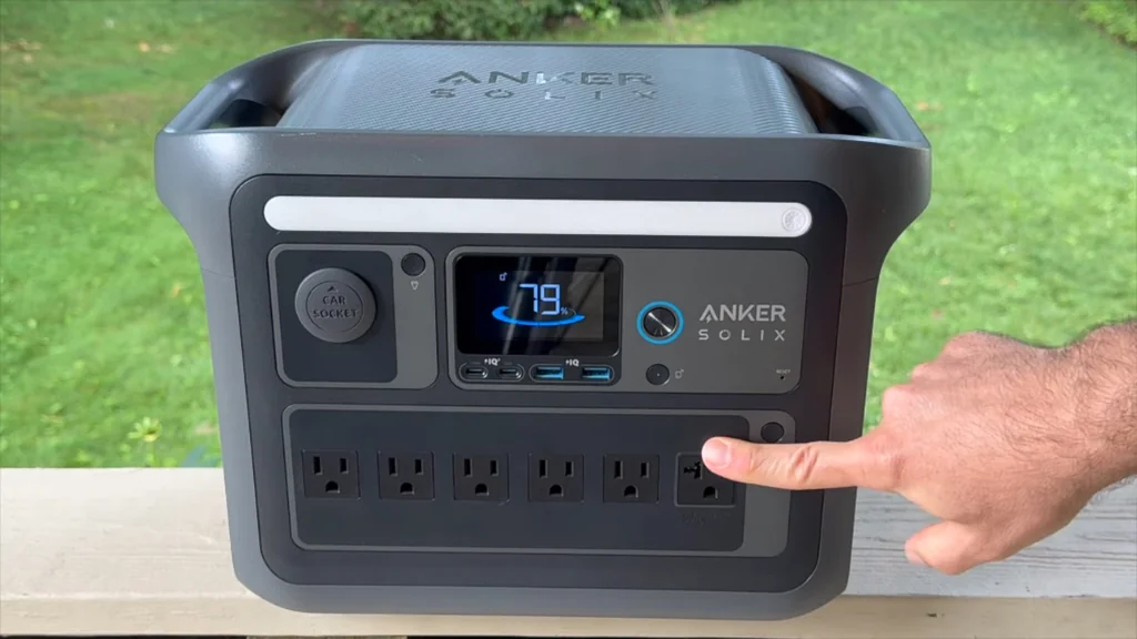 Finger pressing the main power button on the station
