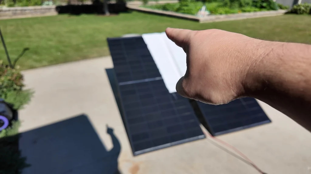 Solar panel partially covered by a board