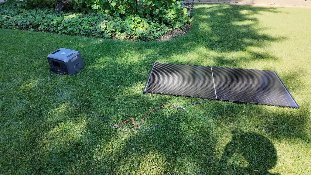 Solar panels and power station on grass