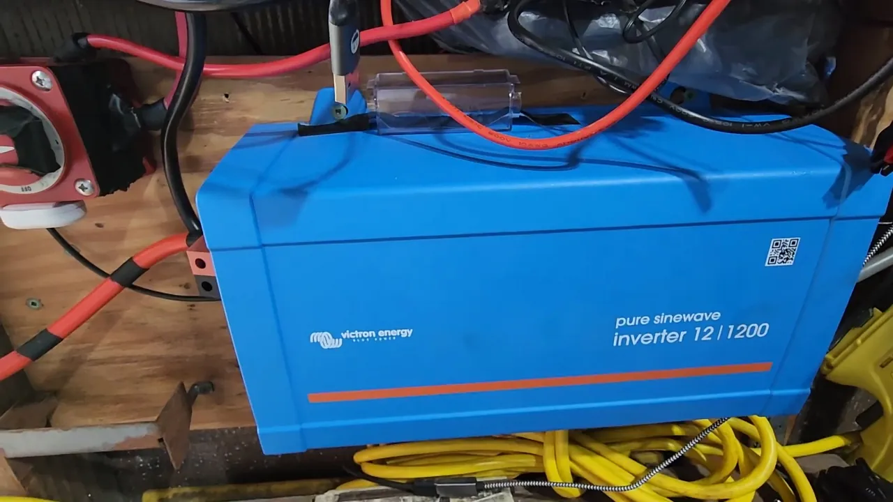 Hand pressing the eco mode button on the inverter