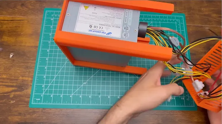 Stripped wiring harness sorted inside the open ATX power supply chassis ready for front terminal connections