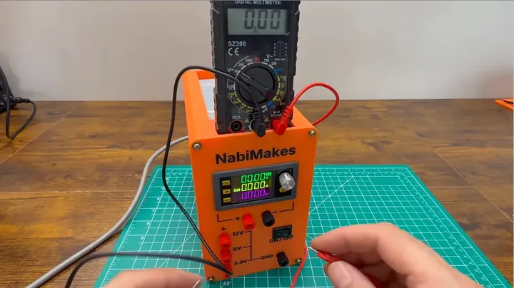 Digital multimeter measuring the output voltage from the front banana jacks of the assembled bench power supply