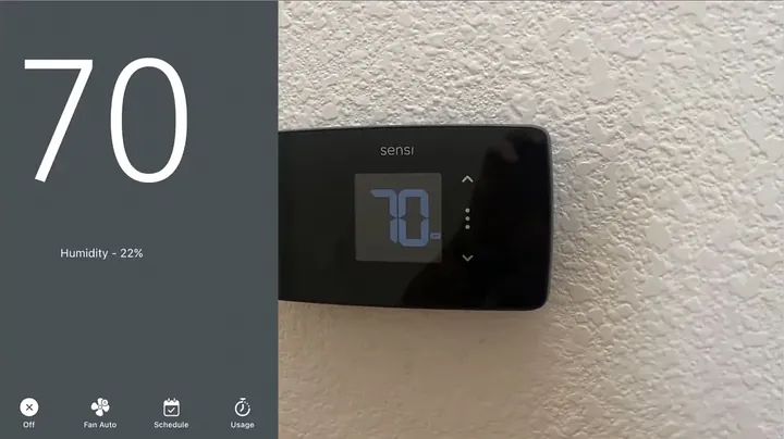 Smartphone displaying thermostat app interface showing active room temperature and cooling mode