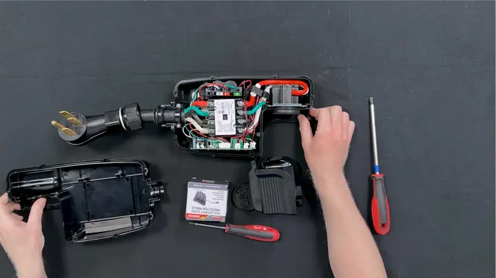Disconnecting wiring harness clip and loosening terminal screws inside casing