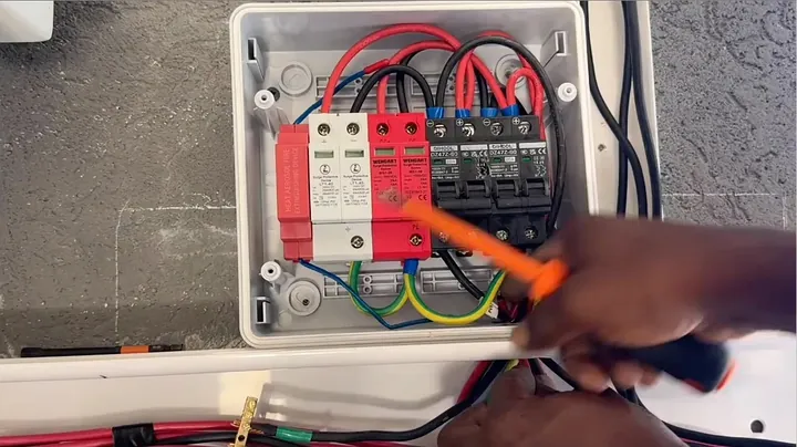 Probing solar array input terminals with digital multimeter to verify voltage polarity