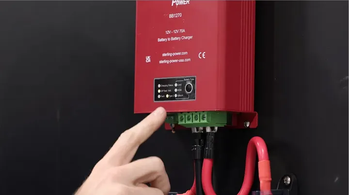 A technician connecting a positive wire to a Mega fuse holder, emphasizing the importance of correct fuse sizing.